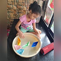 LKG A paper boat sailing activity photos