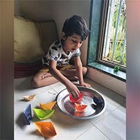 LKG A paper boat sailing activity photos